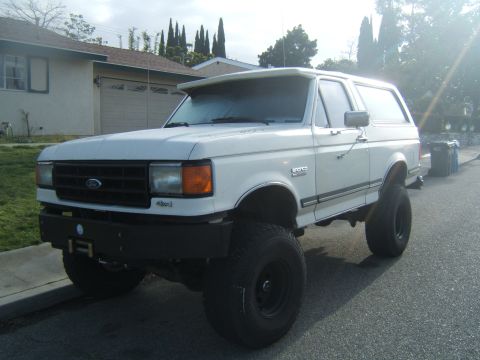 1988 Ford Bronco - This lifted 1988 Ford Bronco features a prominent aftermarket bumper and aggressive off-road tires.