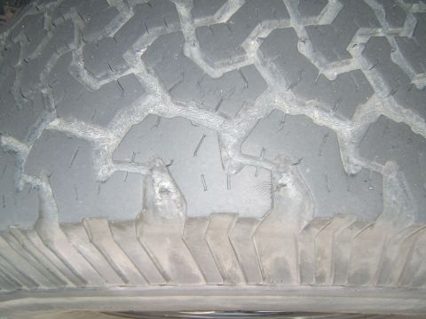 1988 Ford Bronco - Close-up of a worn tire tread, showing the pattern of the rubber.