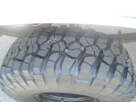 1988 Ford Bronco - This image shows the aggressive tread pattern of a BFGoodrich All-Terrain T/A tire, designed for off-road performance.