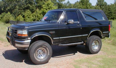 1983 Ford Bronco - This black Ford Bronco has a brush guard and chrome wheels.