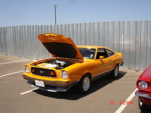 1978 Ford Mustang II - This 1978 Ford Mustang II is parked outdoors with its hood up, revealing the engine compartment.
