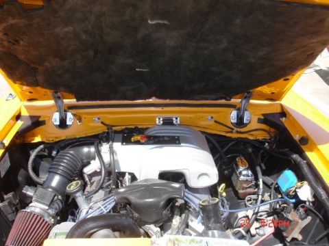 1978 Ford Mustang II - The engine bay of a 1978 Ford Mustang II shows the V8 engine and yellow exterior paint.