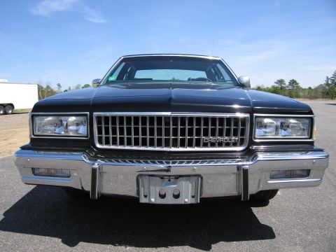 1991 Ford LTD Crown Victoria - Front view of a black Chevrolet sedan with a prominent chrome grille and Chevrolet badging.