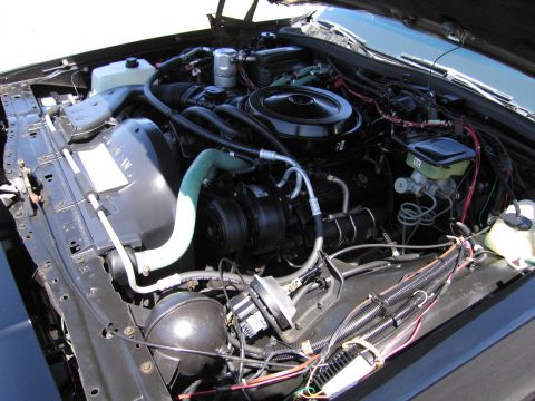 1991 Ford LTD Crown Victoria - The engine bay of a vehicle, various components and wiring.