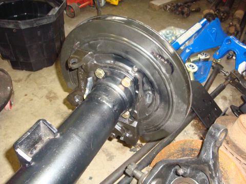 1989 Ford Bronco - Close-up of a rear axle assembly, showing brake components and suspension parts.
