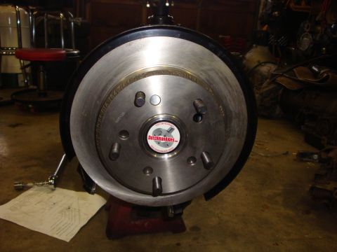 1989 Ford Bronco - A close-up view of a vehicle's brake rotor and hub assembly, showing the wheel studs and brake components.