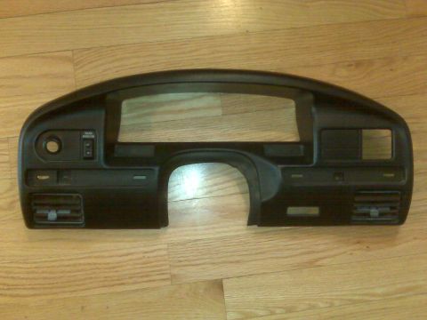 1995 Ford Bronco - Dashboard trim piece for a vehicle, shown on a wooden floor.