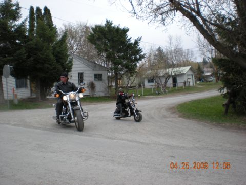 1974 Ford Ranchero - Two motorcycles ride down a dirt road in a rural area on an overcast day.