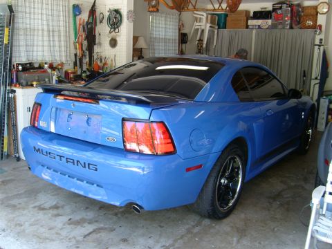 1992 Ford Bronco - Rear view of a blue Ford Mustang, likely from the early 2000s, parked in a garage.