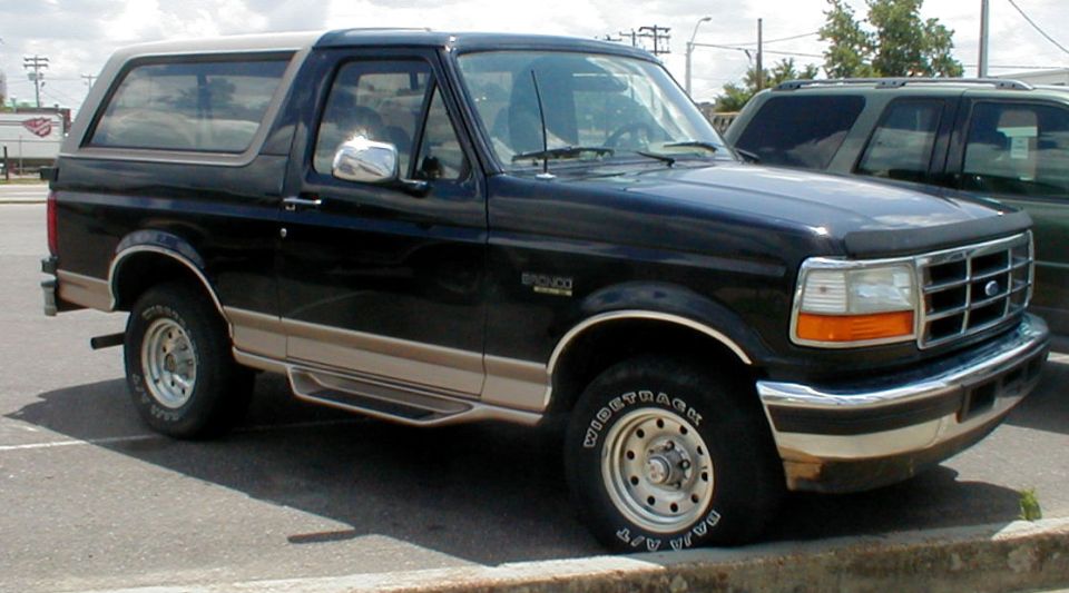 Black and tan Ford Bronco SUV, 3q-front view in parking lot