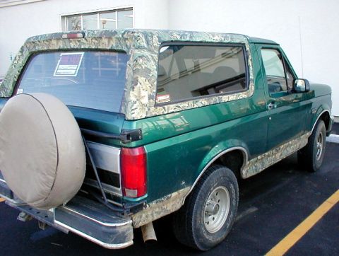 1983 Ford Bronco - '96 Eddie Bauer Bronco with camo wrap on all the tan exterior paint. Note the aftermarket rear bumper that doesn't wrap forward along the b…