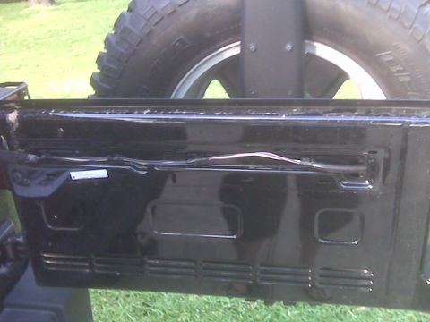 2008 Jeep Wrangler - Rear view of a 2007 Jeep Wrangler showing the spare tire and bumper details.