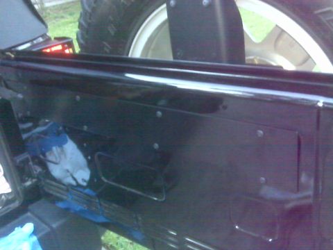 2008 Jeep Wrangler - Close-up view of the interior paneling and spare tire mount in a Jeep Wrangler.