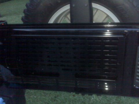 2008 Jeep Wrangler - The rear of a black Jeep Wrangler shows its tailgate and spare tire, with a visible Supermotors.net watermark.