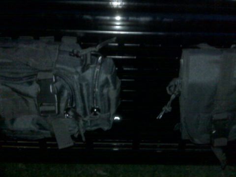 2008 Jeep Wrangler - Molle pouches are secured to a rack, likely for storage or organization.