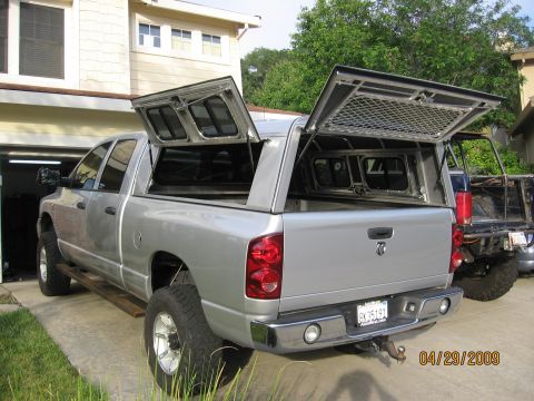 2007 Dodge 2500 - Silver Dodge pickup truck with an open camper shell, parked in a driveway next to another vehicle.