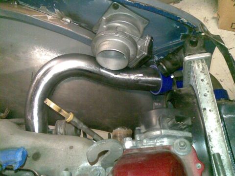 1969 MINI Cooper - Custom intercooler piping and throttle body assembly on an engine. Part of a radiator is visible.