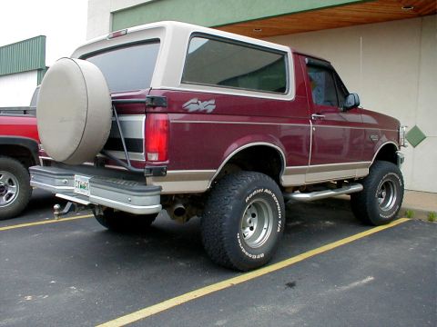 1983 Ford Bronco - This lifted Ford Bronco has a spare tire mounted on the rear door and off-road tires.
