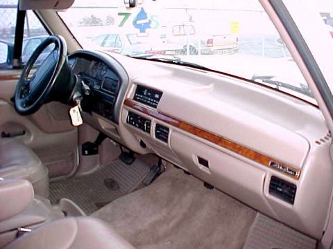 1983 Ford Bronco - The dashboard of a truck shows the steering wheel, radio, and air vents.