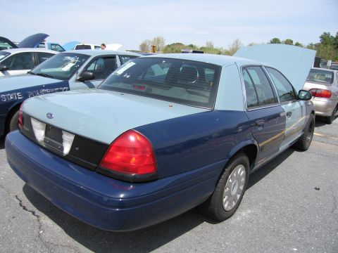 2001 Ford Crown Victoria - This 2001 Ford Crown Victoria is parked in an outdoor lot, with other vehicles visible around it.