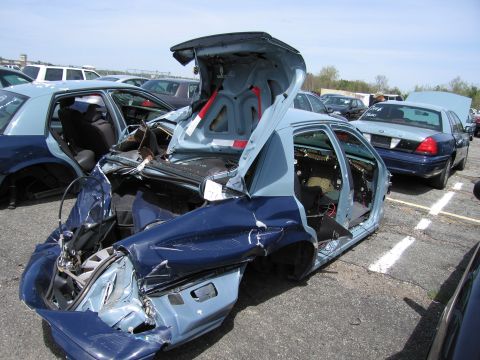 2001 Ford Crown Victoria - This heavily damaged 2001 Ford Crown Victoria is seen in a junkyard, with its trunk and rear end severely compromised.