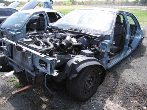 2001 Ford Crown Victoria - This car is missing its front end and body panels, revealing the engine and interior components.
