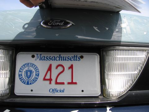 2001 Ford Crown Victoria - The Ford emblem and Massachusetts license plate are visible on the rear of the vehicle.