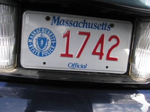 2001 Ford Crown Victoria - Close-up of a Massachusetts State Police license plate reading '1742 Official'.