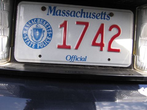 2001 Ford Crown Victoria - Close-up of a Massachusetts State Police license plate reading '1742 Official'.