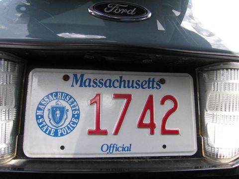 2001 Ford Crown Victoria - Close-up of a Ford emblem and a Massachusetts State Police license plate on the rear of a vehicle.
