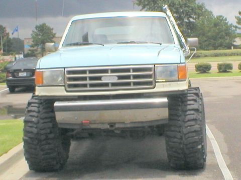 1983 Ford Bronco - This heavily modified pickup truck features oversized tires and a snorkel, suggesting off-road capabilities.