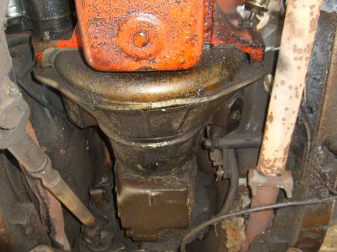 1994 Ford Bronco - Close-up of the engine's oil pan and exhaust system, showing signs of wear and tear.
