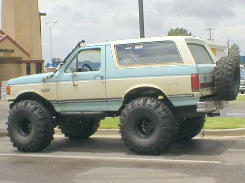 1983 Ford Bronco - Modified Ford Bronco with large off-road tires and a snorkel attachment.