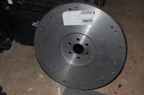 1994 Ford Bronco - A metal flywheel with a part number label is shown, with a black object in the background.