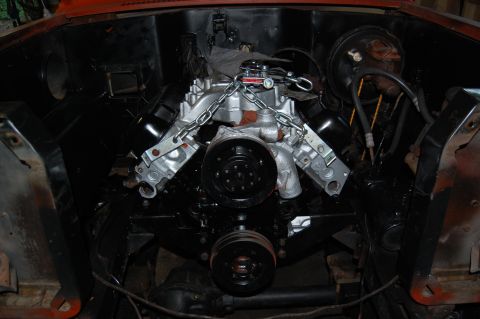 1994 Ford Bronco - Engine bay view showing a V8 engine with chains for support during installation.