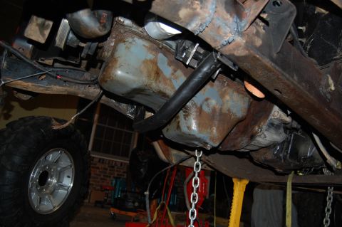 1994 Ford Bronco - The underside of a vehicle is shown, with focus on the engine oil pan and suspension components.