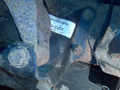 1995 Ford Bronco - A close-up view of a vehicle's suspension component, a part number label.