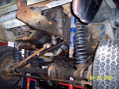 1979 Ford Bronco - Undercarriage view of a vehicle's suspension and drivetrain components.