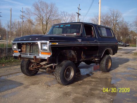 1979 Ford Bronco - This black Ford Bronco has a lifted suspension and a 4x4 decal on the windshield.