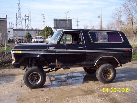 1979 Ford Bronco - This black Ford Bronco, likely a 1978 model, is shown with a lifted suspension and prominent chrome trim.