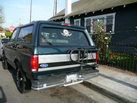 1991 Ford Bronco - Rear view of a 1991 Ford Bronco showing its distinctive body style and a bike rack.