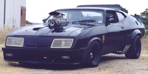 1991 Ford Bronco - Customized black coupe with a supercharger and side exhaust pipes.