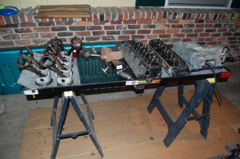 1994 Ford Bronco - Engine components laid out on a table for inspection or repair.