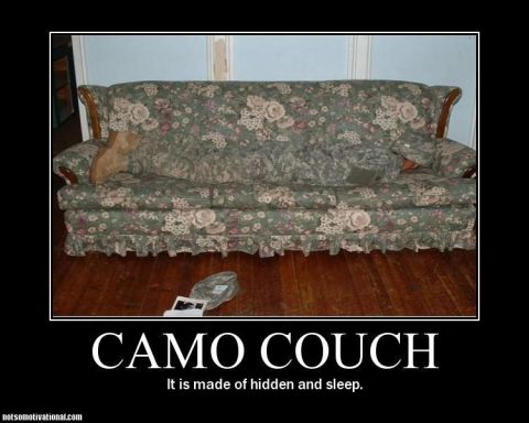 1990 Ford Bronco - A couch with a camouflage pattern is shown, with a person partially hidden on it.