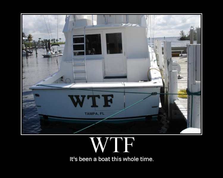 Boat docked with WTF and TAMPA, FL on the stern. Another boat is visible in the background