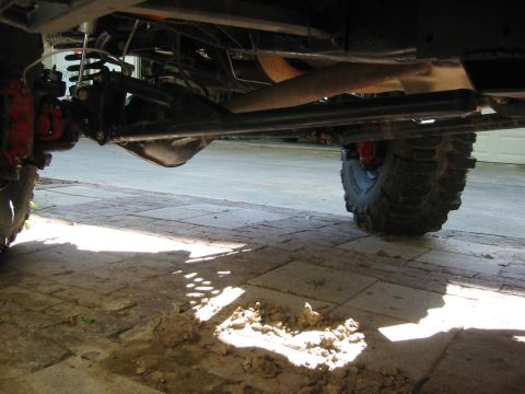 1995 Ford Bronco - Close-up view of the undercarriage and suspension system of a vehicle.
