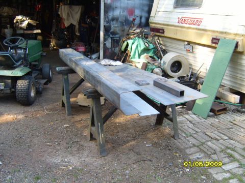 1989 Ford Bronco - Metal fabrication project underway in a cluttered garage setting with a lawn tractor and RV visible.