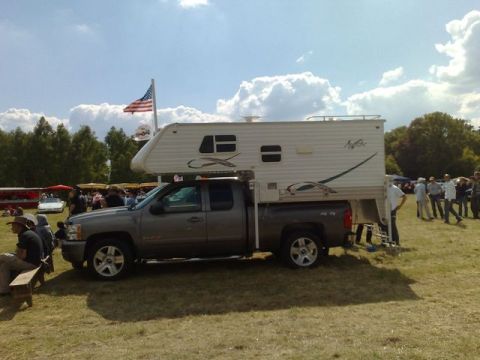 1991 Ford LTD Crown Victoria - A pickup truck is equipped with a camper shell for outdoor adventures.