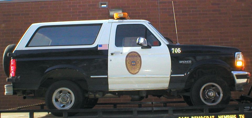 Black and white Ford Bronco police vehicle unit 705 with roof light bar