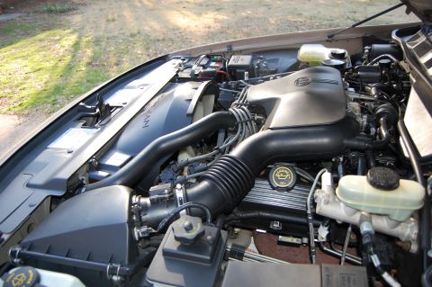 1996 Mercury Grand Marquis - Close-up view of a car's engine bay, showing various components and hoses.